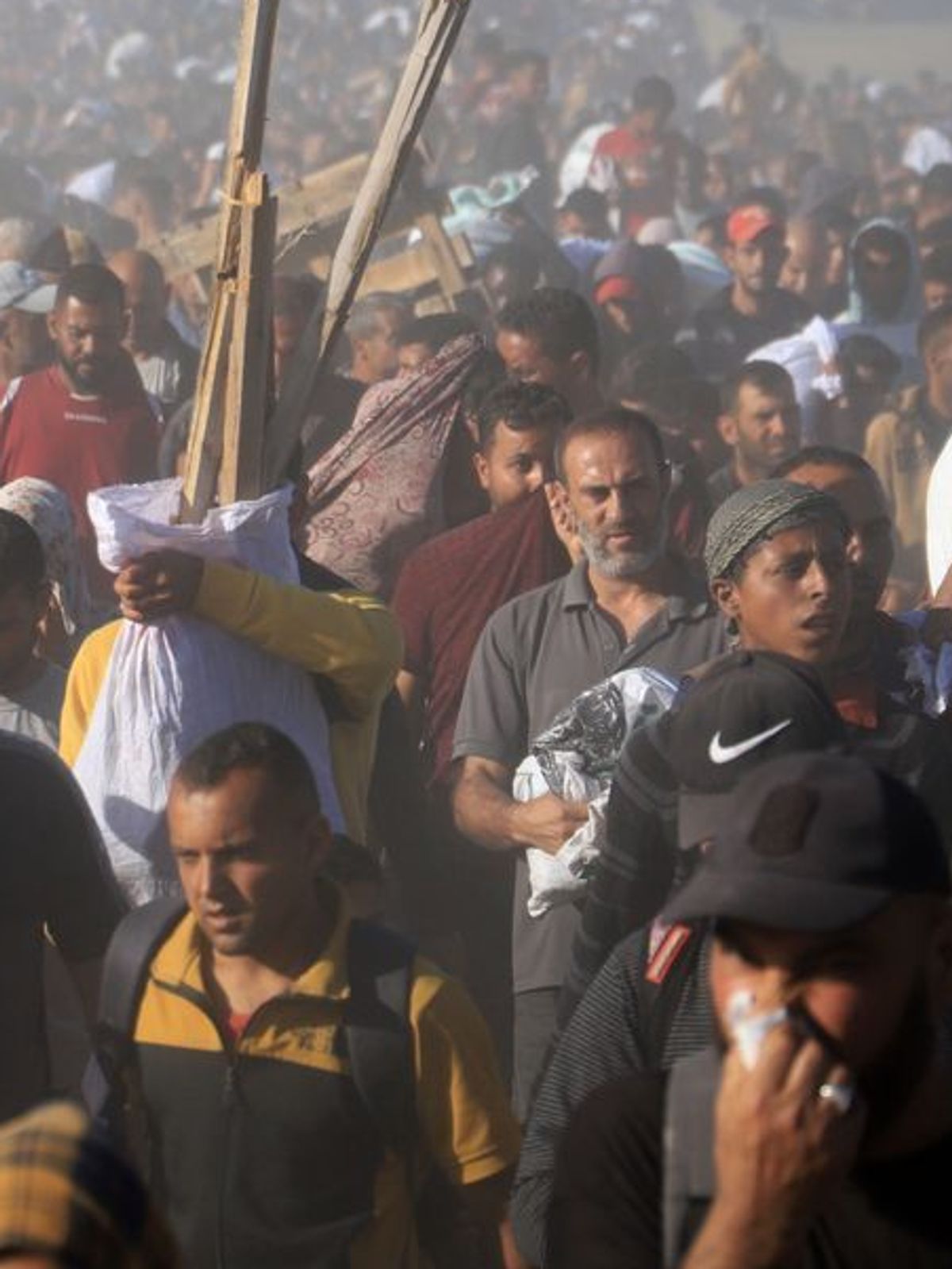 Palästinenser tragen Kisten und Taschen mit Lebensmitteln und humanitären Hilfspaketen - dabei sollen sieben von ihnen durch das israelische Militär getötet worden sein. 