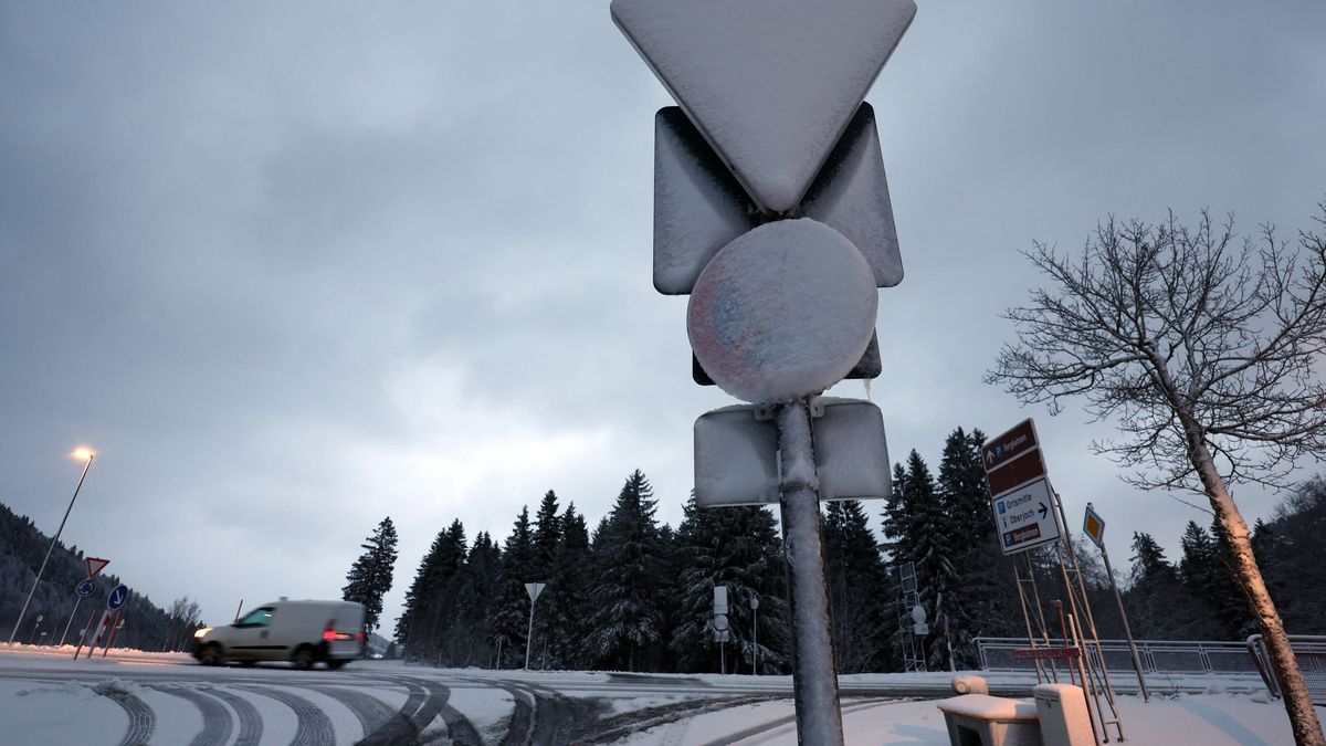 Verkehrsschilder sind am frühen Morgen im Ortsteil Oberjoch mit Schnee bedeckt.