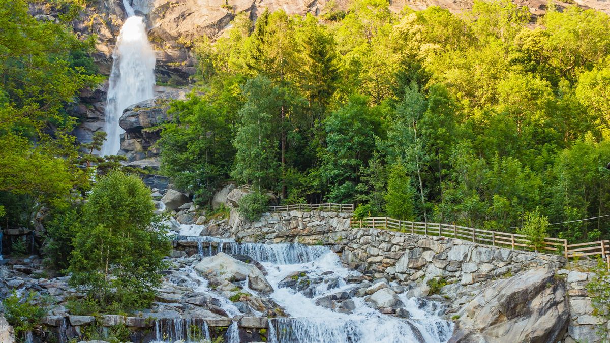 The particular waterfall of Noasca in Piedmont/ Italy is located behind the houses on the border of the famous Great Paradise National Park