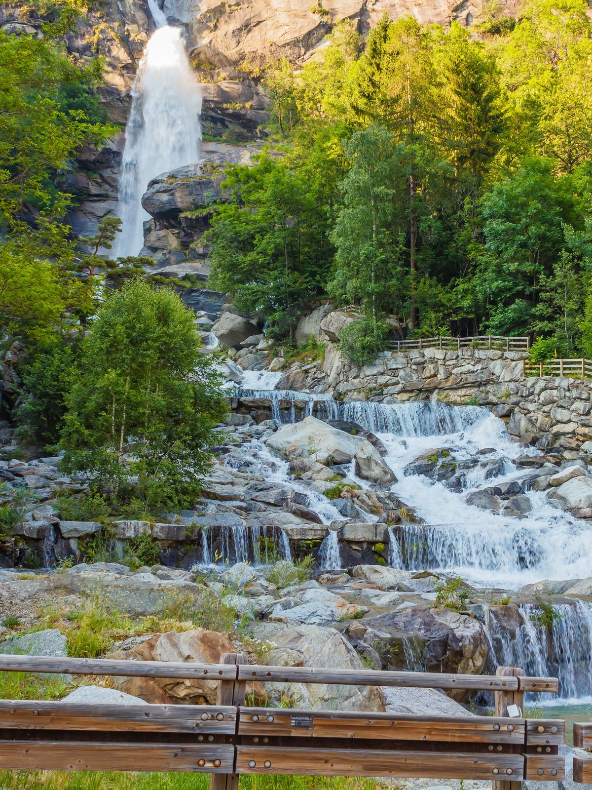 The particular waterfall of Noasca in Piedmont/ Italy is located behind the houses on the border of the famous Great Paradise National Park