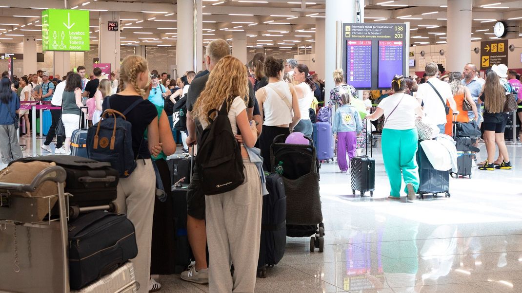 Touristen müssen am Flughafen Palma auf verspätete Flüge warten.