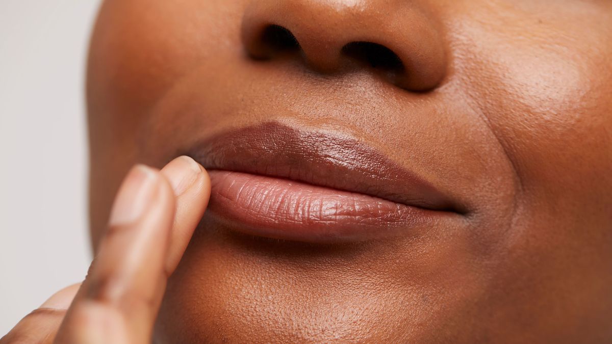Close-up of woman touching lips