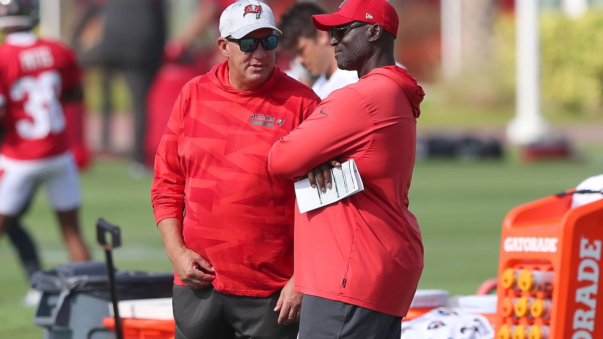 TAMPA, FL - JUN 13: Tampa Bay Buccaneers General Manager Jason Licht and Head Coach Todd Bowles watch the action on the field as they talk during the Tampa Bay Buccaneers Minicamp on June 13, 2023 ...