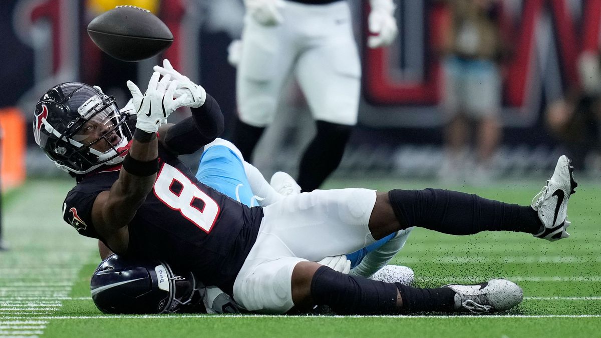 Houston Texans wide receiver John Metchie III (8) drops a. Pass under pressure from Tennessee Titans cornerback Daryl Worley (35) during the fourth quarter at NRG Stadium in Houston, Texas on Sunda...