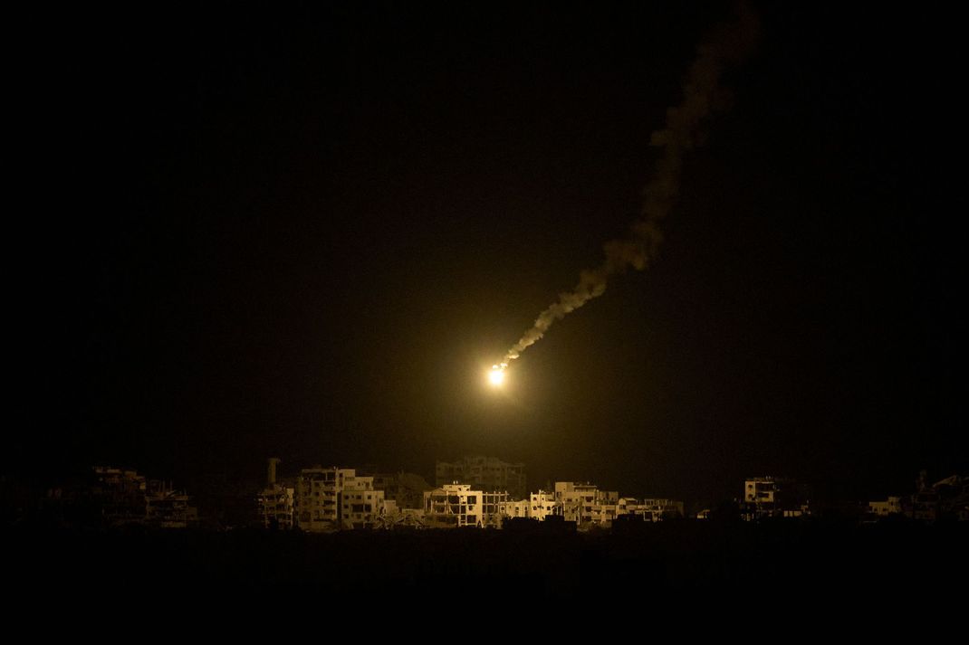 Eine Leuchtrakete der israelischen Armee ist über Gebäuden zu sehen, die während der israelischen Boden- und Luftoperationen im nördlichen Gazastreifen zerstört wurden,