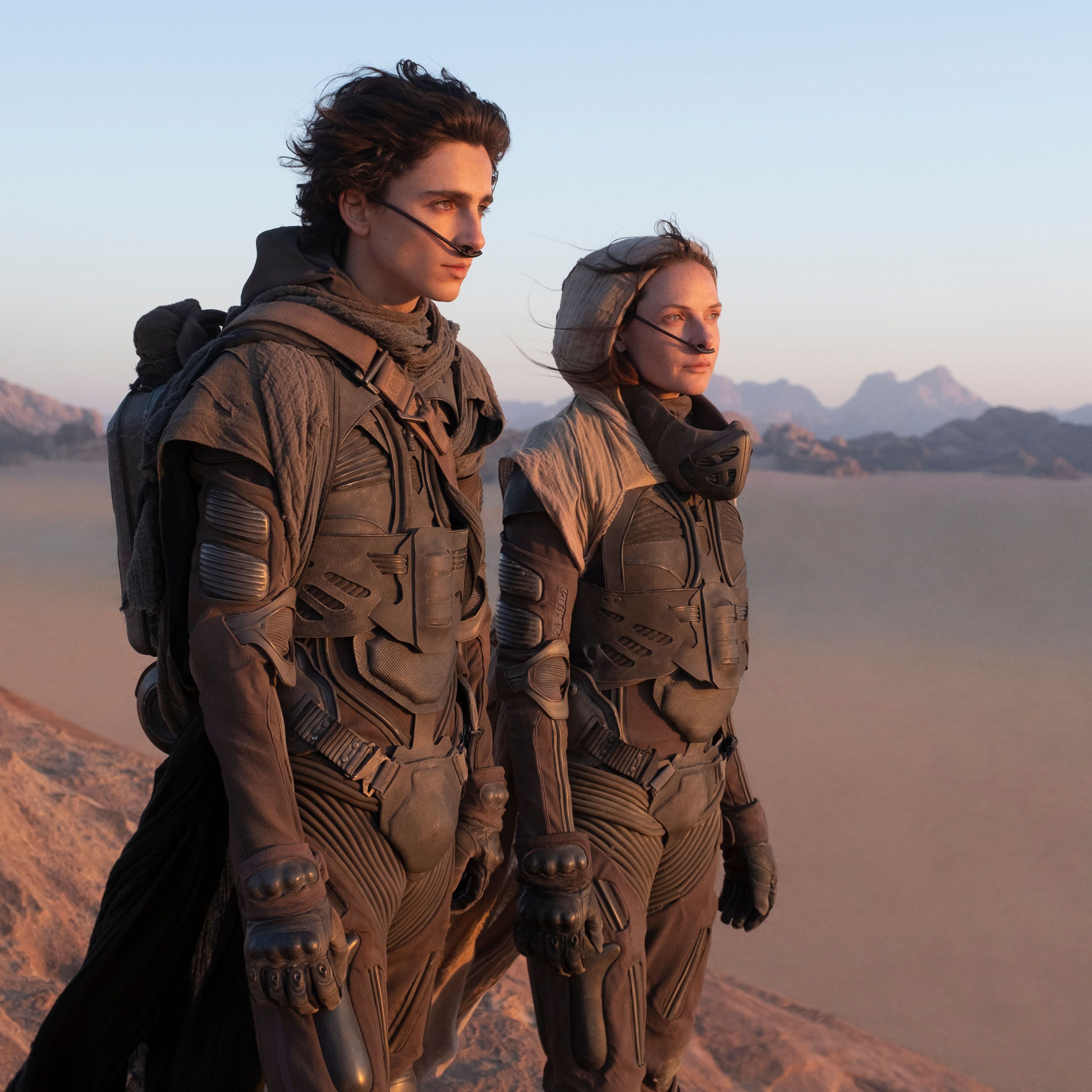 This image released by Warner Bros. Entertainment shows Timothee Chalamet, left, and Rebecca Ferguson in a scene from the upcoming 2021 film "Dune." The film will premiere at the 78th Venice International Film Festival. (Chia Bella James/Warner Bros. Entertainment via AP)