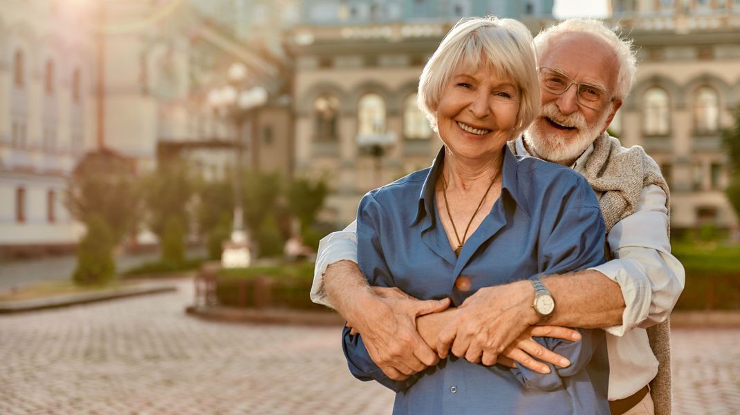 Love has no age limit. Happy senior couple in casual clothing embracing each other and smiling while standing outdoors