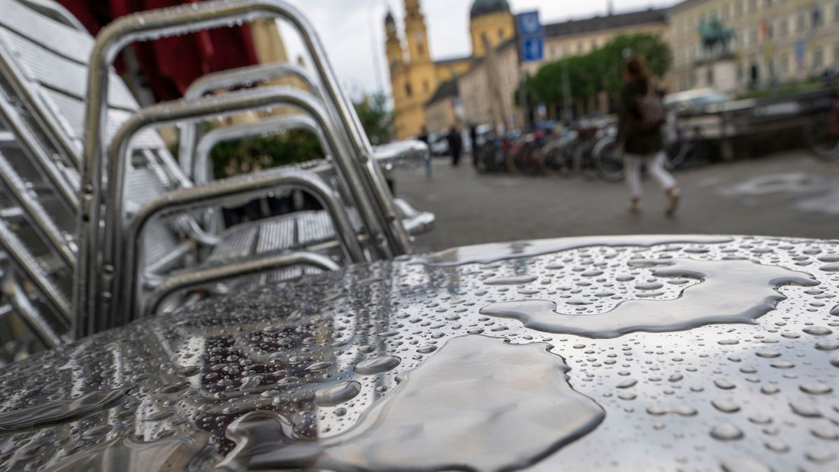 Regenwasser ist auf einem Metalltisch eines Strassencafés in der Innenstadt.