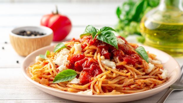 Spaghetti pasta with tomato sauce, mozzarella cheese and fresh b