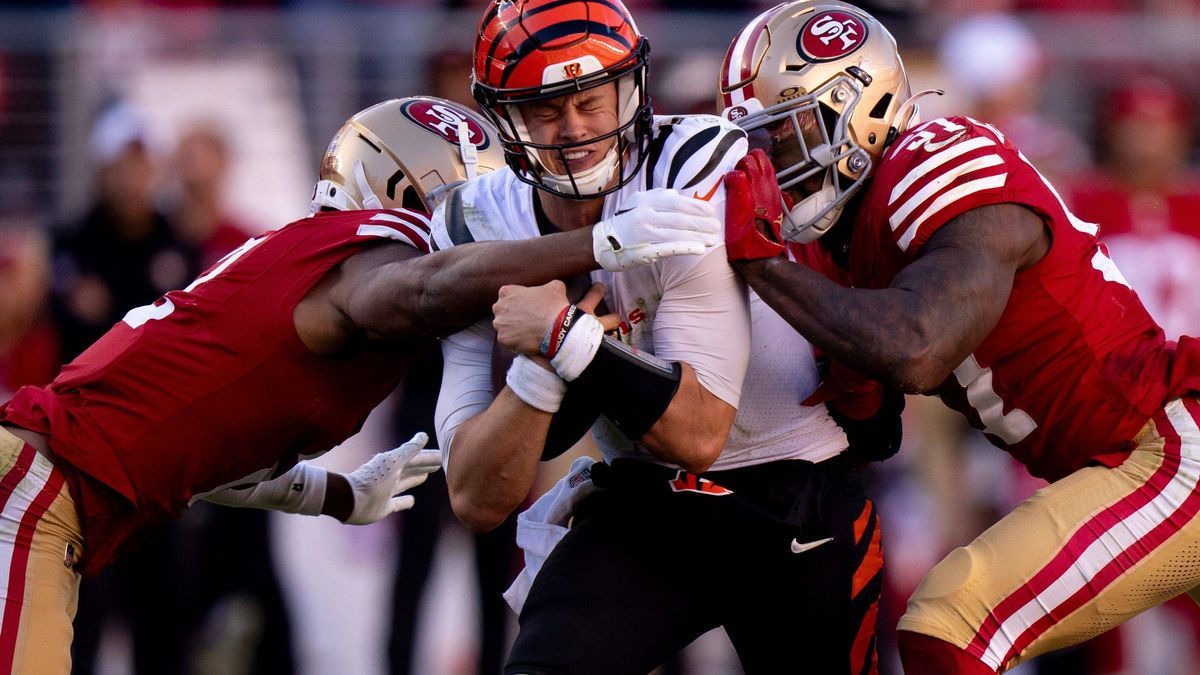 Syndication: The Enquirer Cincinnati Bengals quarterback Joe Burrow (9) is hit by San Francisco 49ers cornerback Deommodore Lenoir (2) and San Francisco 49ers linebacker Dre Greenlaw (57) after run...