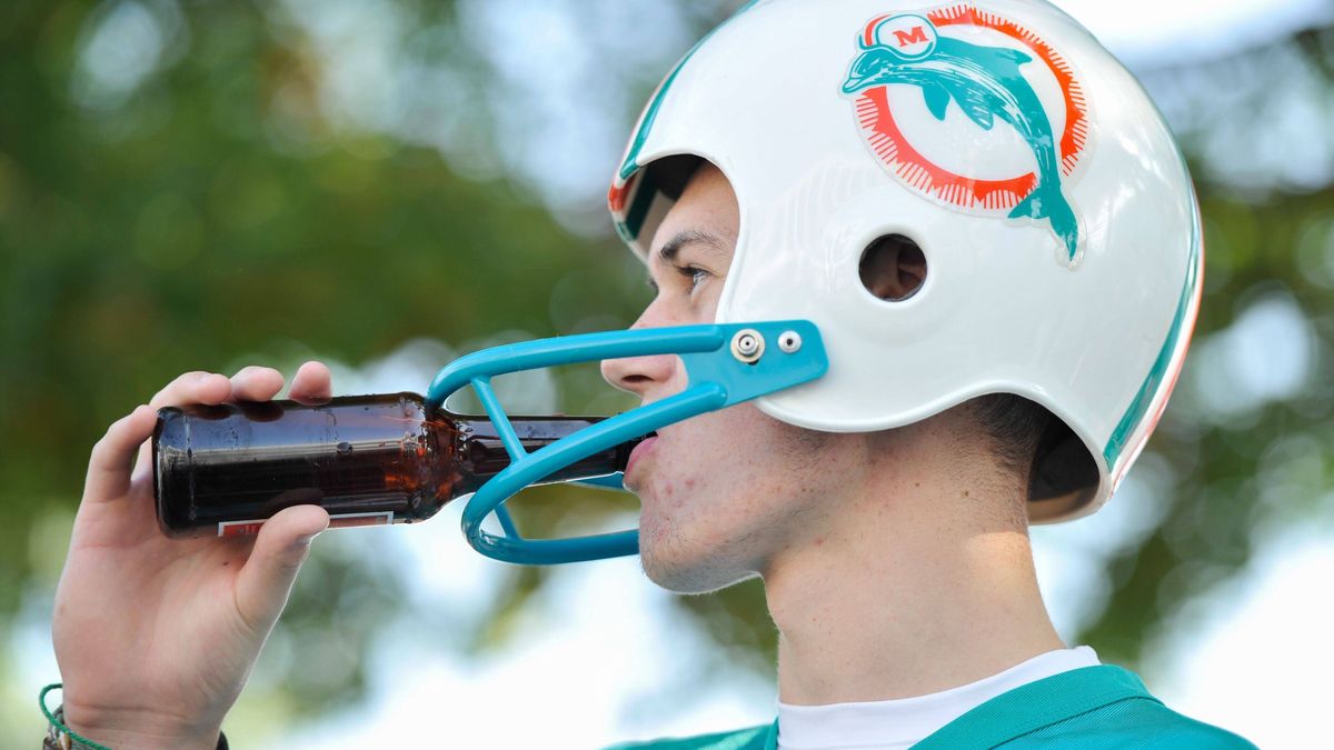 Mandatory Credit: Photo by Joe Toth BPI Shutterstock (5212756i) A Miami Dolphins fan tries to drink a beer through his helmet during the NFL, American Football Herren, USA Week 4 game between Miami...