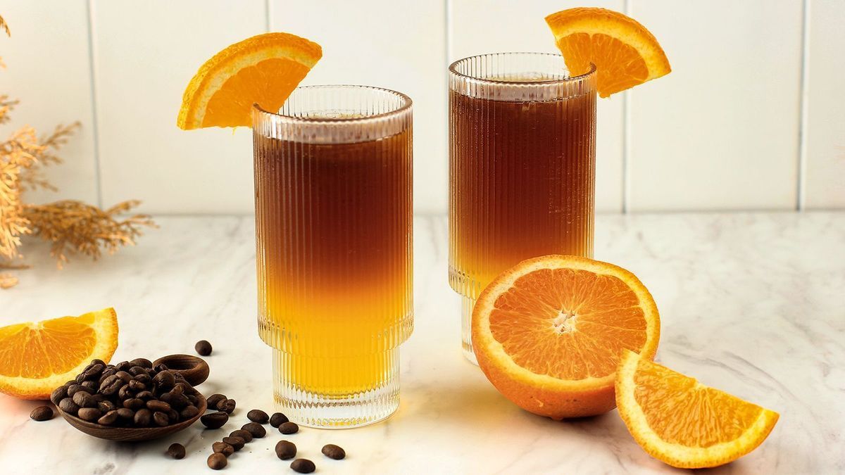 Iced Orange Espresso Coffee Mocktail Cold Brew Tonic Spritz on White Background, Concept Menu for Coffee Shop