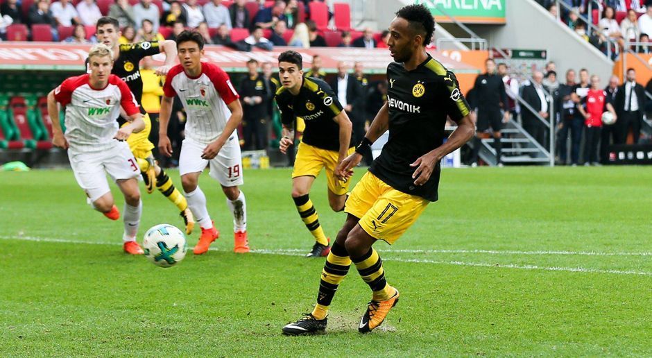 
                <strong>Pierre-Emerick Aubameyang</strong><br>
                Oft der Dortmunder Dosenöffner - heute sind das aber andere. Aubameyang ist die meiste Zeit bei den Augsburger Innenverteidigern in guten Händen. Hat in der 32. Minute dann die große Chance zum 3:1, als er einen weiten Ball erst klasse annimmt, vor dem Tor aber dann vertändelt - leichtfertig! Erst in Minute 70 wieder in Erscheinung, als er einen Kopfball aus sieben Metern zu zentral platziert. Zehn Minuten wohl später mit dem peinlichsten Elfmeter des Jahres, als er den Ball wie Panenka in die Mitte chippen will, Hitz aber einfach stehen bleibt. Arroganz-Anfall, und das bei einem Spielstand von 2:1. Naja. ran-Note: 6
              