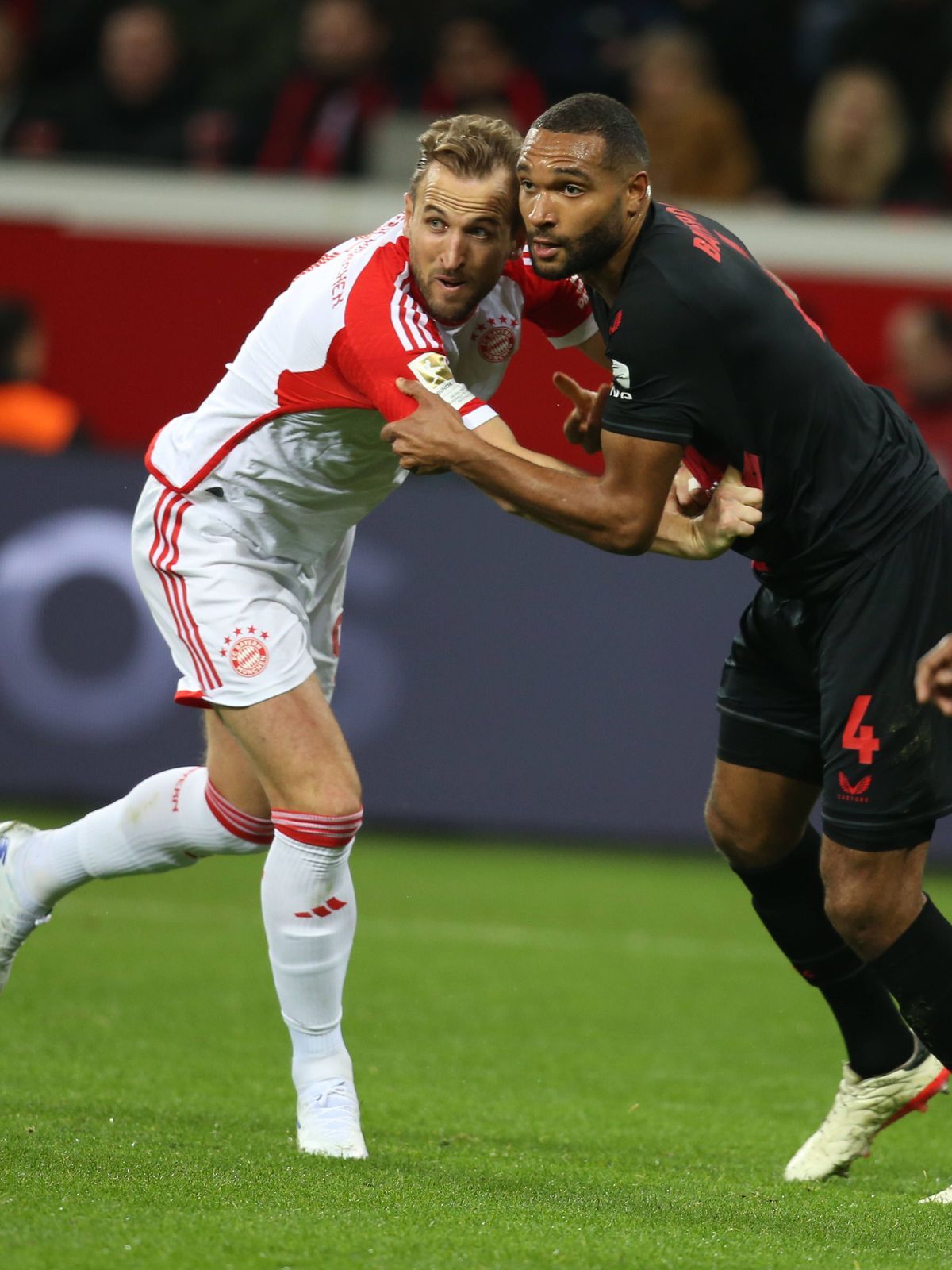 February 10, 2024, Leverkusen, Germany: Jonathan Tah of Leverkusen (R), fights for the ball against Harry Kane of Bayern Munich during the Bundesliga match between Leverkusen and Bayern Munich at B...