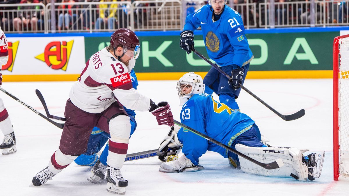 RIGA, LATVIA - MAY 20: goalkeeper Andrey Shutov of Kazakhstan (R) saves on Rihards Bukarts of Latvia (L) during the 2023 IIHF Ice hockey, Eishockey World Championship, WM, Weltmeisterschaft Finland...