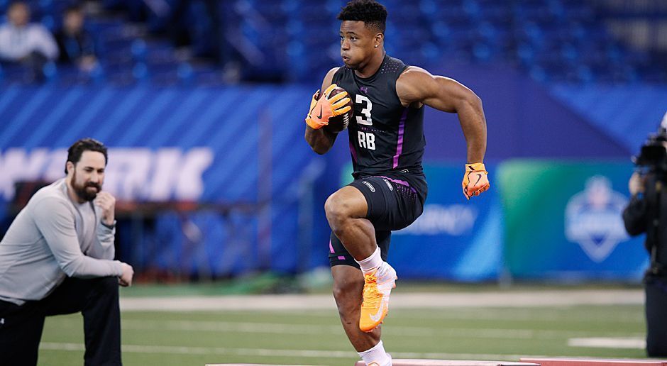 
                <strong>2. Pick - New York Giants: RB Saquon Barkley</strong><br>
                Obwohl Running Backs in den letzten Jahren selten so früh gedraftet wurden (abgesehen von Elliott und Fournette), braucht Eli Manning eine weitere großartige Waffe in der Offense. Saquon Barkley von Penn State ist einer der die Chance hat, irgendwann das gelbe Jackett zu tragen. Er macht geile Jump Cuts, Spin Moves und ist schnell wie der Blitz. 4,40 Sekunden über 40 Yards im Combine und State Champion über 100 Meter in Pennsylvania. Jede Saison über 1000 Yards und über 50 Touchdowns. Eli würde es ihm danken.
              