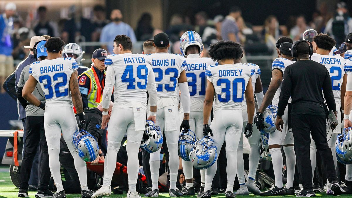 ARLINGTON, TX - OCTOBER 13: Detroit Lions players watch as Detroit Lions defensive end Aidan Hutchinson (97) is loaded up on a cart after an injury during the game between the Dallas Cowboys and th...