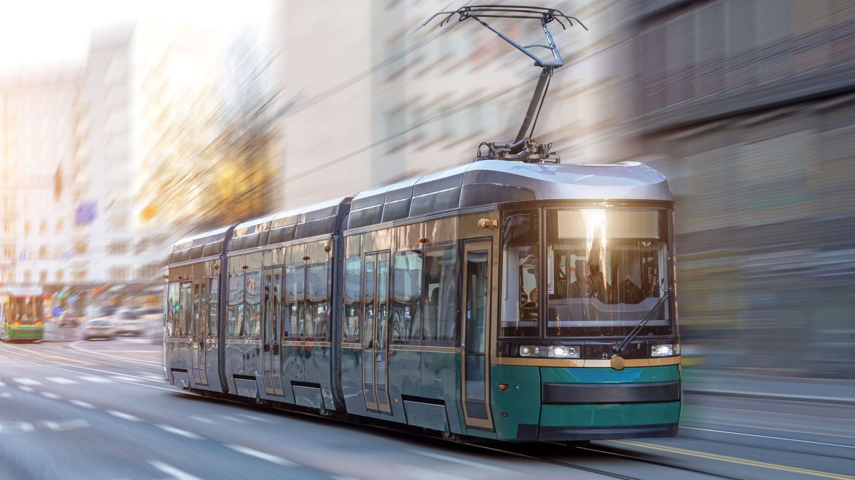 City tram rides through the streets of the city at a motion speed effect.