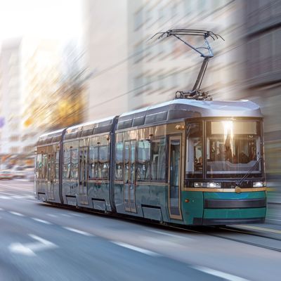 City tram rides through the streets of the city at a motion speed effect.