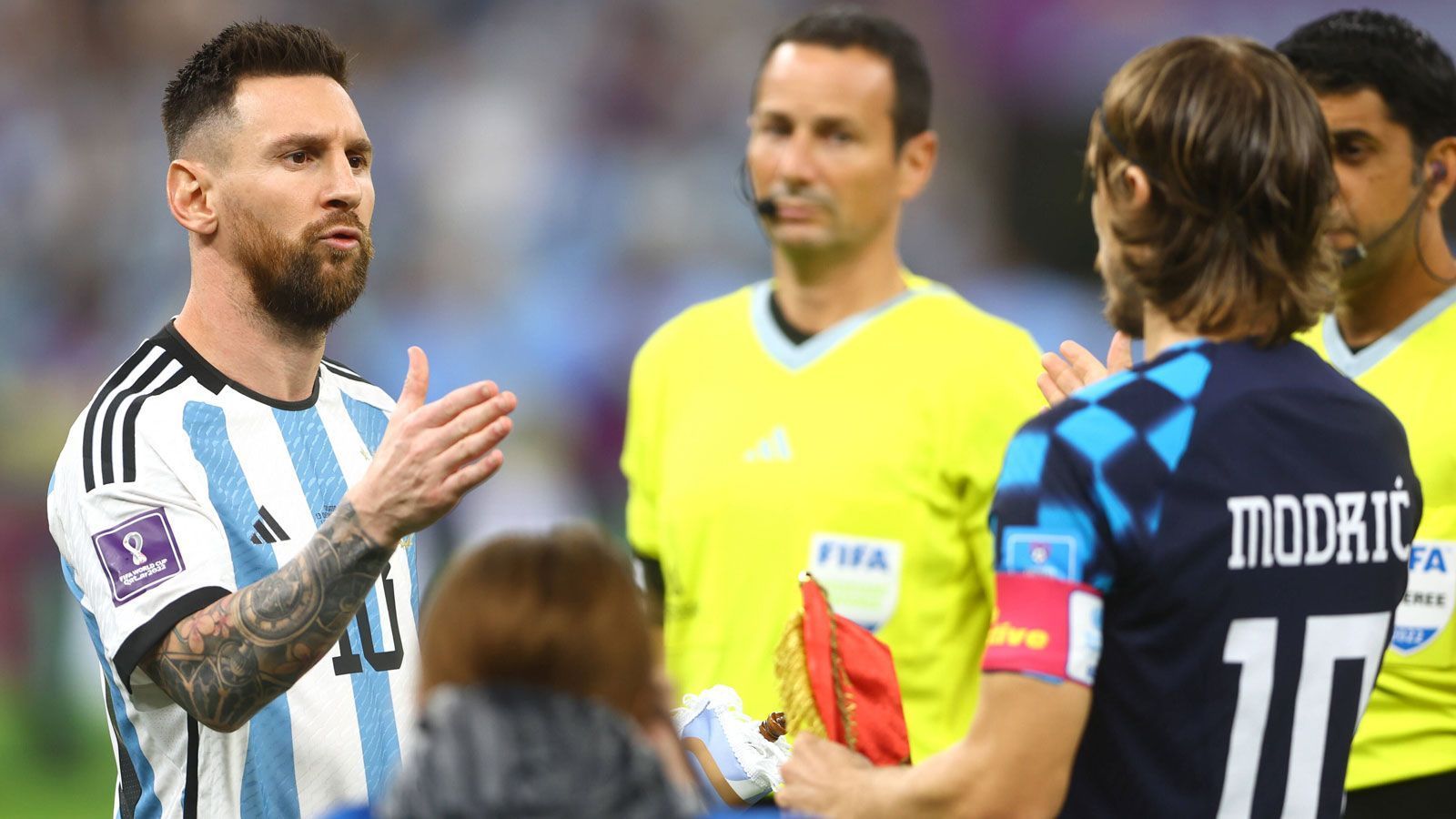 
                <strong>Shakehands der Weltstars</strong><br>
                Vor dem Anpfiff treffen sich Messi und Modric beim Schiedsrichtergespann, um auszuknobeln, wer den Anstoß ausführt. Ob sich die langjährigen Rivalen aus La Liga auch ein gutes Spiel wünschen? Jedenfalls wissen sie schon im Moment des Shakehands: Es kann nur einen geben.
              