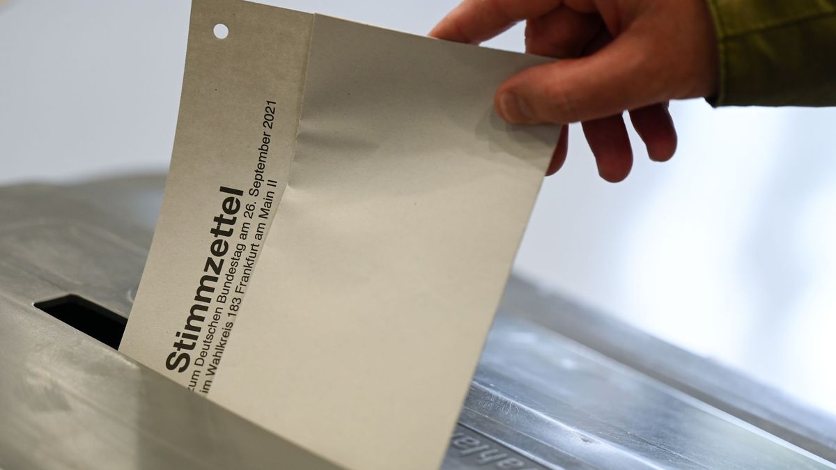 Stimmzettel wird in eine Wahlurne gesteckt