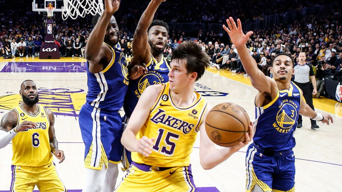 May 12, 2023, Los Angeles, California, USA: Los Angeles Lakers guard Austin Reaves (15) looks to pass while defended by Golden State Warriors forwards Draymond Green (23), Andrew Wiggins (22) and g...