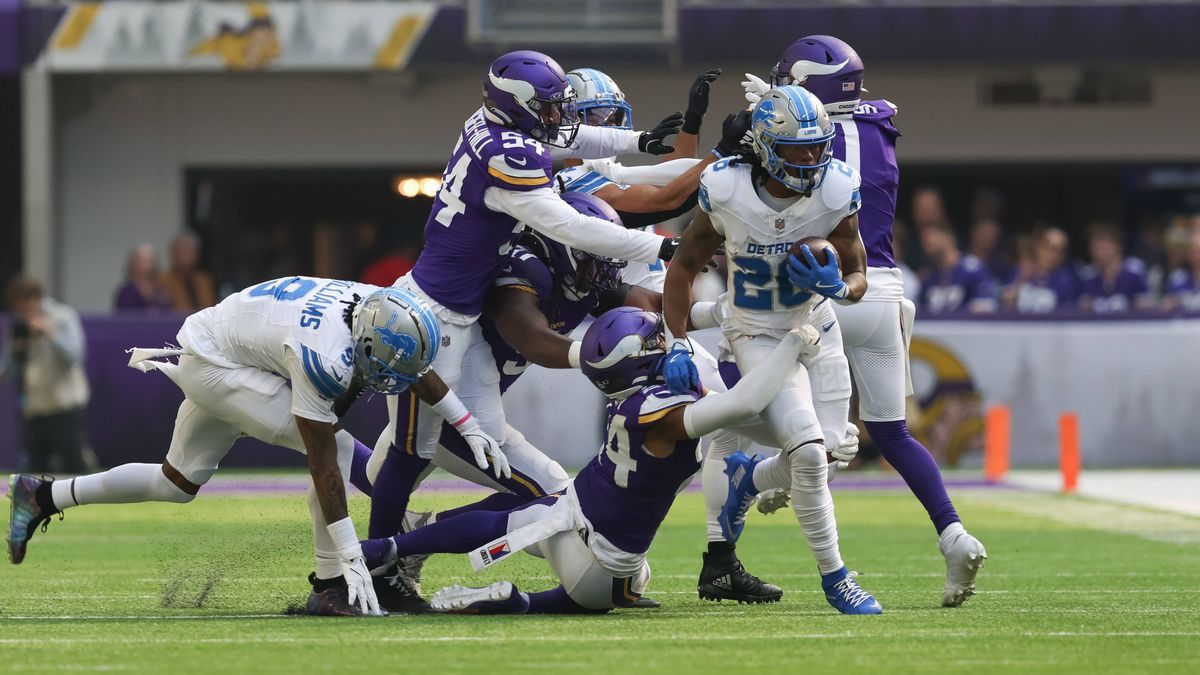 MINNEAPOLIS, MN - OCTOBER 20: Detroit Lions running back Jahmyr Gibbs (26) runs the ball while being tackled by Minnesota Vikings safety Camryn Bynum (24) during the NFL, American Football Herren, ...