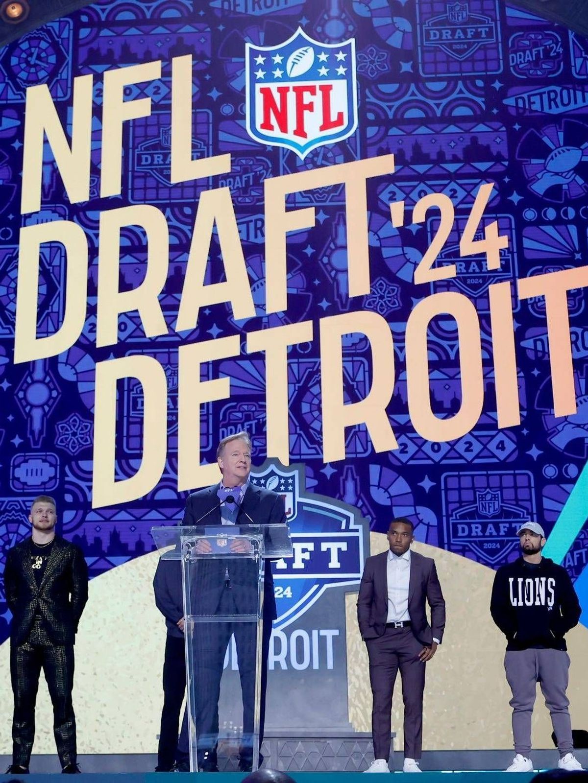 Syndication: Detroit Free Press NFL commissioner Roger Goodell addresses the crowd with Eminem and the Detroit Lions Jared Goff, Amon-Ra St. Brown and Aidan Hutchinson and Hall of Famers Calvin Joh...