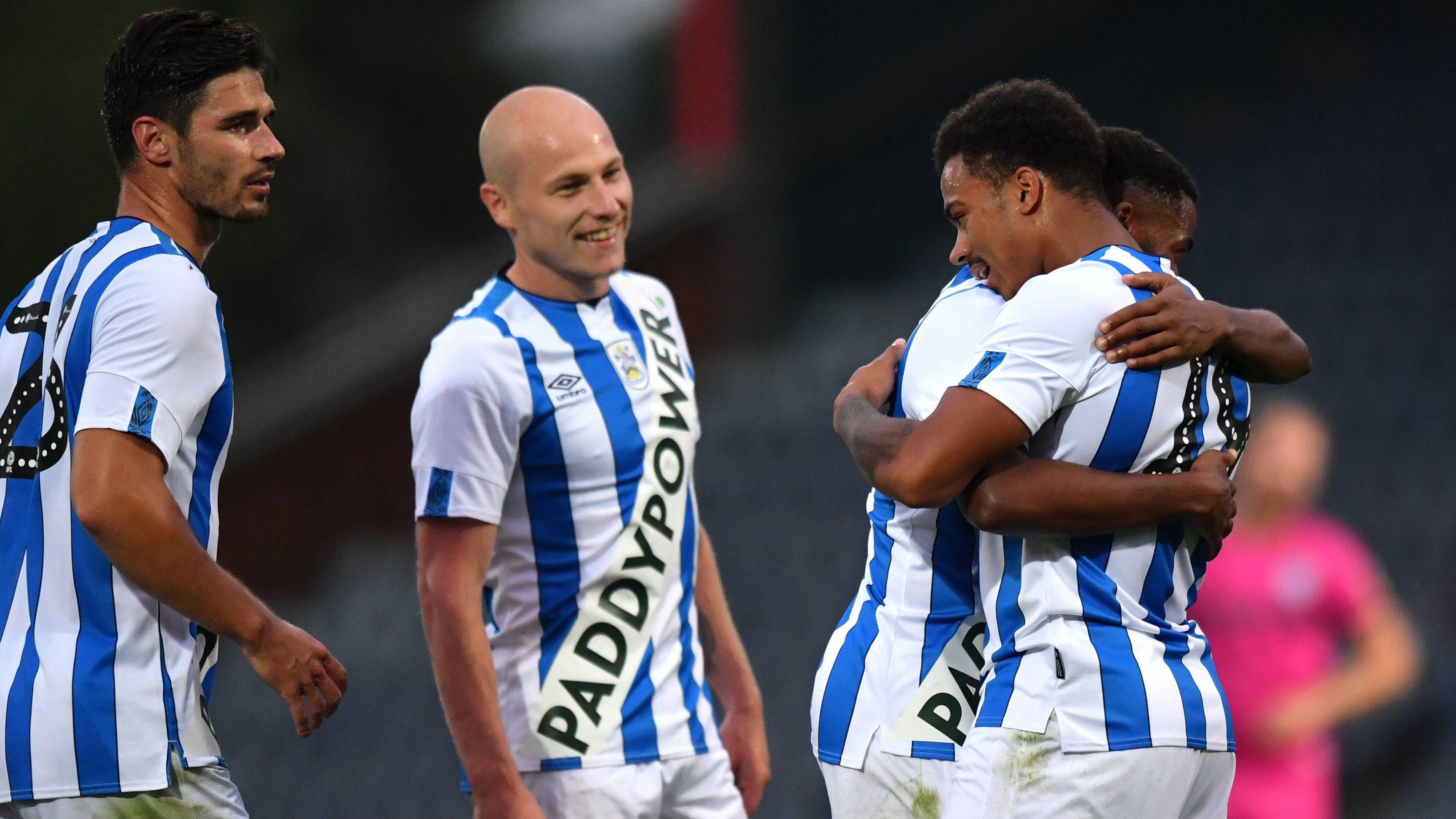 
                <strong>Huddersfield Town</strong><br>
                Mit einem großen Schriftzug diagonal über das Trikot sorgte Premier League-Absteiger Huddersfield Town für Aufsehen. In den sozialen Netwerken erntete das Trikot viel Hohn und Spott. Der englische Fußballverband kündigte sogar Ermittlungen wegen eines möglichen Regelverstoßes gegen Trikotwerbung an. Nun gab der Verein auf Twitter bekannt: Alles nur insziniert, im Rahmen einer Kampagne.
              