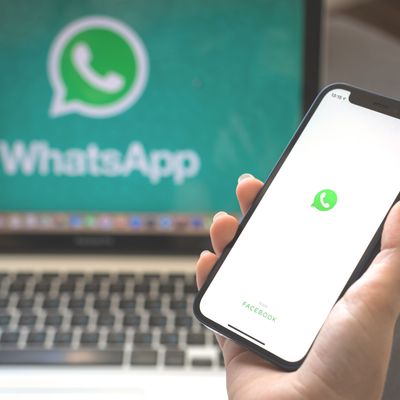 Kharkov, Ukraine - August 23, 2021: Whatsapp app logo on mobile phone screen. Woman using Whatsapp application