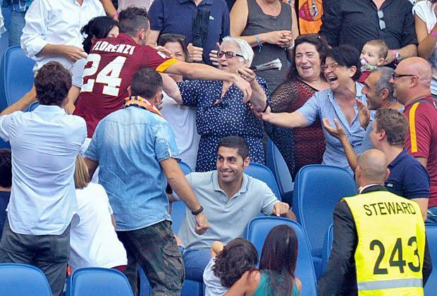 
                <strong>Lass dich drücken</strong><br>
                Da ist die Glückbringerin: In einem vollen Stadion ist es für einen Fußballer normalerweise nicht so leicht, einen Bekannten zu entdecken. Doch vielleicht hat die Oma ihrem Enkel ja ihre Sitzplatznummer vor dem Spiel verraten ...
              