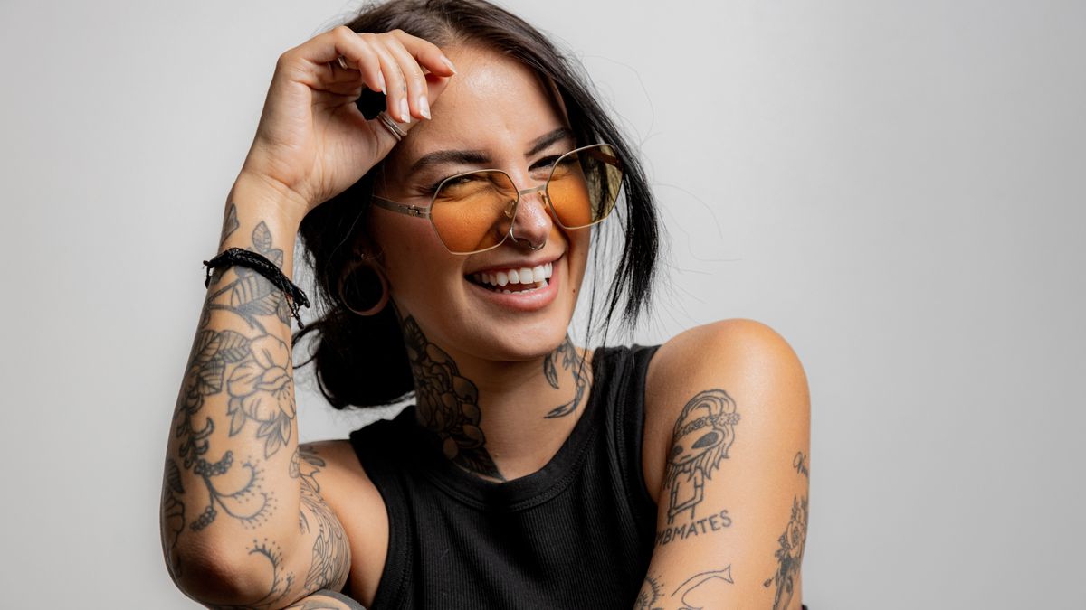 portrat of a Gen Z tattoo girl laughing