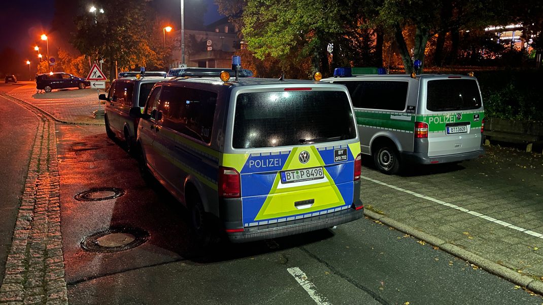 Polizeifahrzeuge stehen vor der Gesamtschule in Hollfeld (Landkreis Bayreuth), die nach einer Bombendrohung geschlossen ist. 