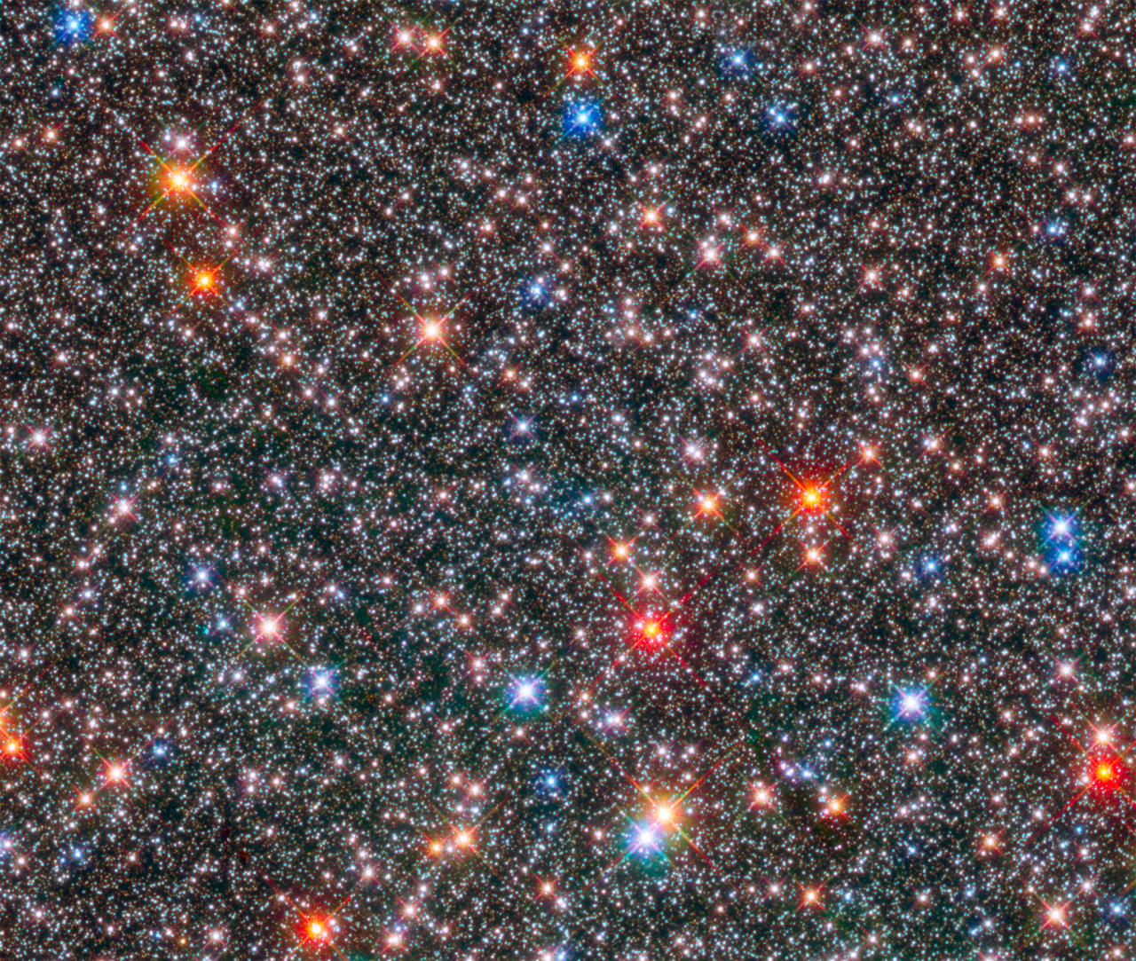 Bei uns vor der Haustüre ist ganz schön viel los. Das beweist ein Foto des Zentrums unserer Milchstraße. Dieses ist "nur" 26.000 Lichtjahre von der Erde entfernt. Das Foto ist eine Komposition aus Infrarotstrahlung und sichtbarem Licht.