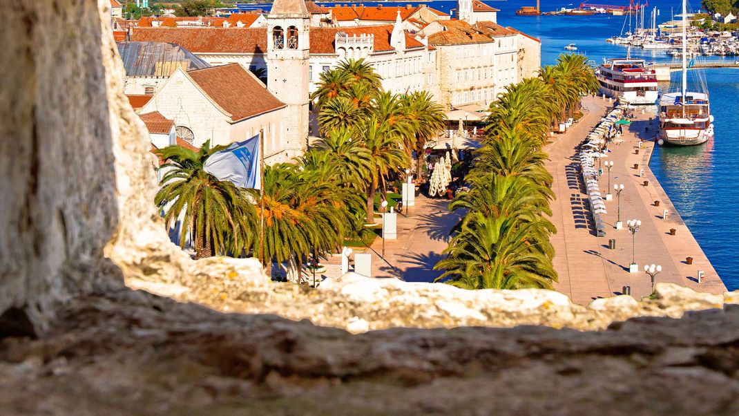 Town of Trogir waterfront and landmarks panoramic view through stone window