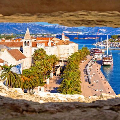 Town of Trogir waterfront and landmarks panoramic view through stone window