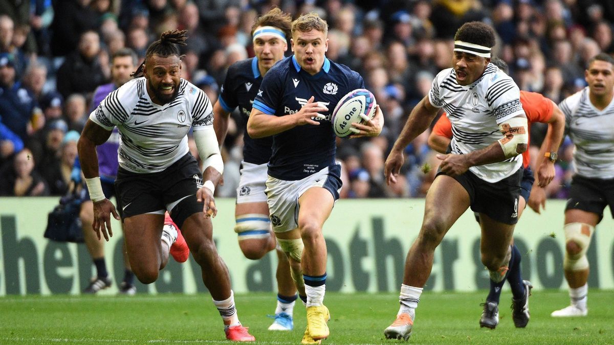 Mandatory Credit: Photo by David Gibson Fotosport Shutterstock (13609930aa) Darcy Graham - Scotland s man-of-the-match bursts through the Fiji cover as Waisea Nayacalevu and Vinaya Habosi give chas...