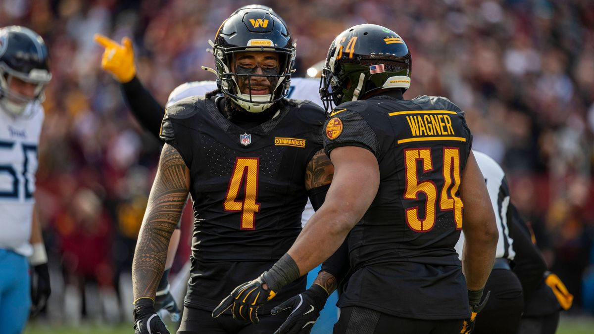 LANDOVER, MD - DECEMBER 01: Washington Commanders linebacker Frankie Luvu (4) and Washington Commanders linebacker Bobby Wagner (54) celebrate together after causing a fumble during the Tennessee T...