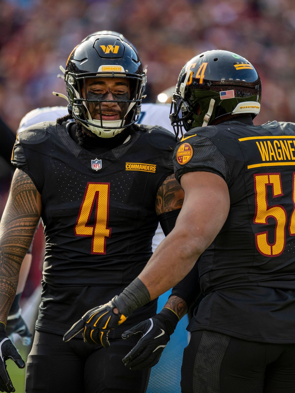 LANDOVER, MD - DECEMBER 01: Washington Commanders linebacker Frankie Luvu (4) and Washington Commanders linebacker Bobby Wagner (54) celebrate together after causing a fumble during the Tennessee T...