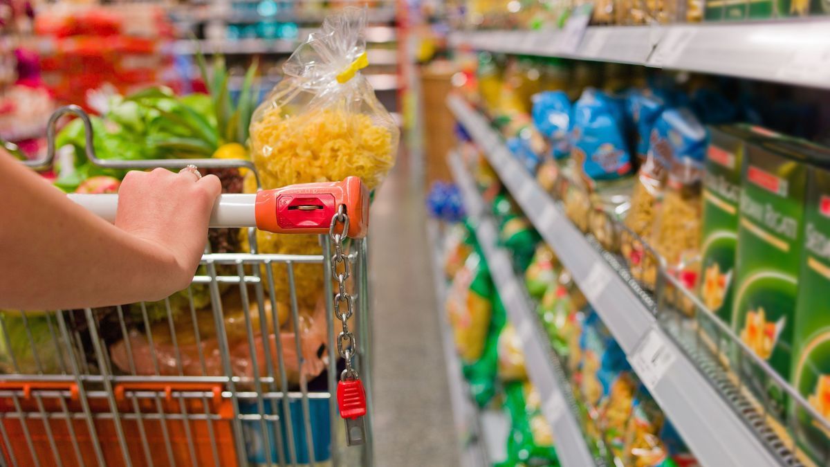 Frau mit Einkaufswagen im Supermarkt