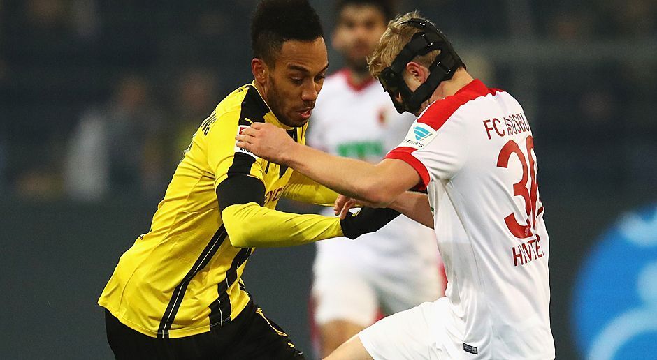 
                <strong>Pierre-Emerick Aubameyang</strong><br>
                Pierre-Emerick Aubameyang: Mit einem guten Freistoß in der 12. Minute machte Auba den Anfang, fand jedoch in Hitz seinen Meister. Hatte in Halbzeit eins zwei weitere Chancen und hätte mit einem Kopfball das 1:1 machen können, wenn nicht sogar müssen. Ein ständiger Unruheherd in der FCA-Defensive, auch wenn er ohne Tor blieb. ran-Note: 3+.
              