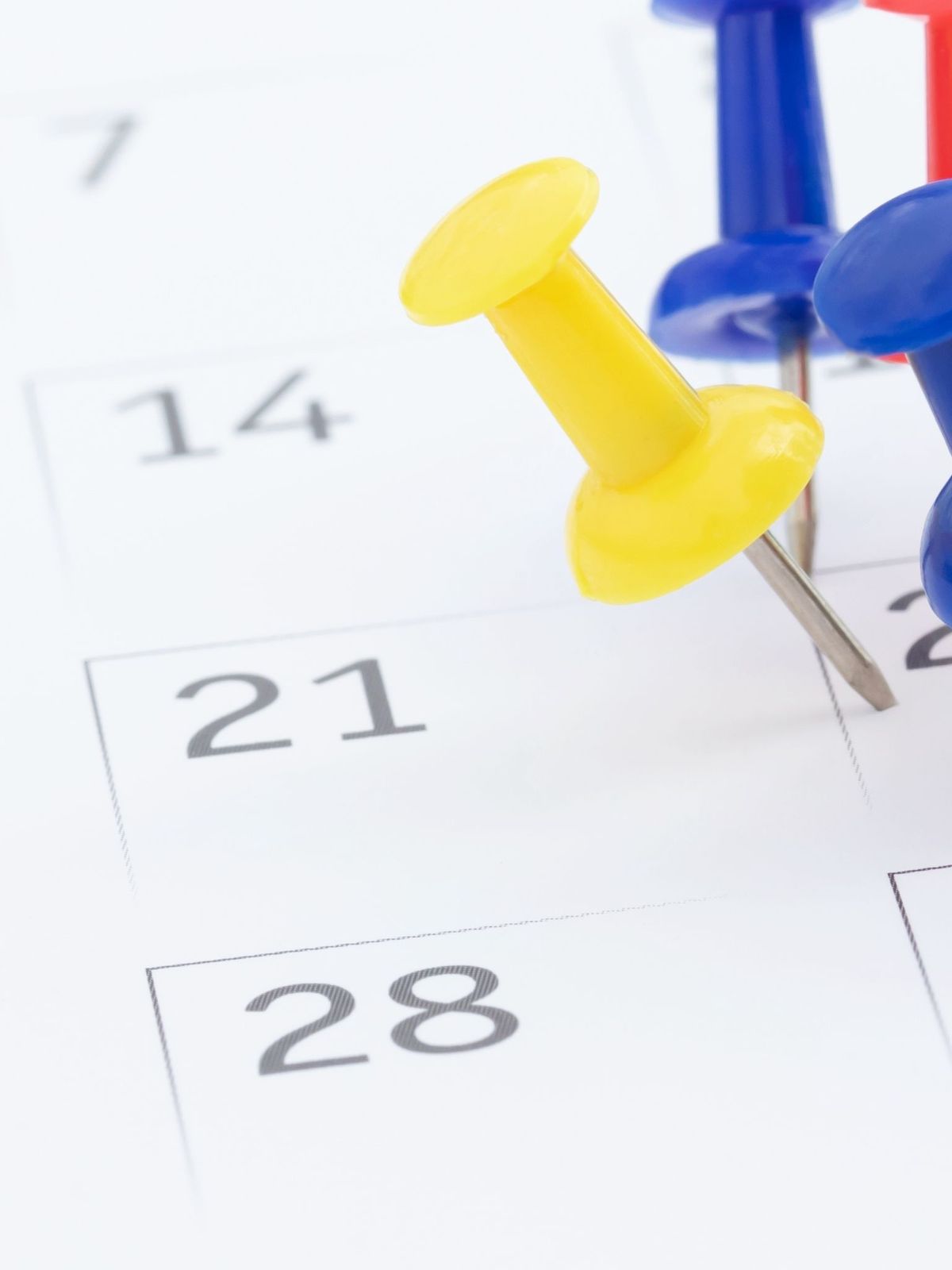 mark the event day with a pin Thumbtack in calendar concept for busy timeline organize schedule,appointment reminder. planning business meeting or travel holiday planning concept. soft focus