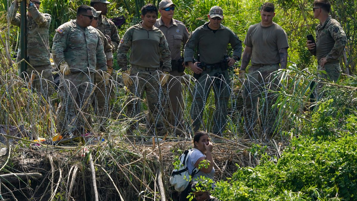 US-Polizisten beobachten eine Migrantin auf mexikanischer Seite.