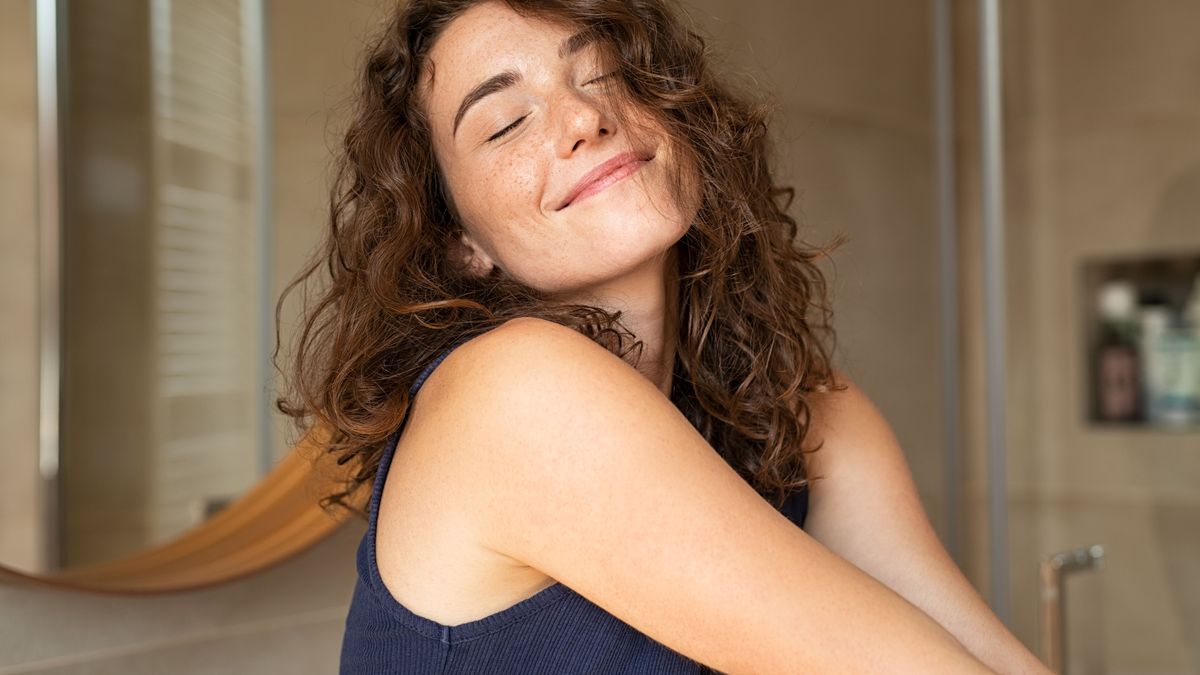 Woman stretching in bathroom after wake up