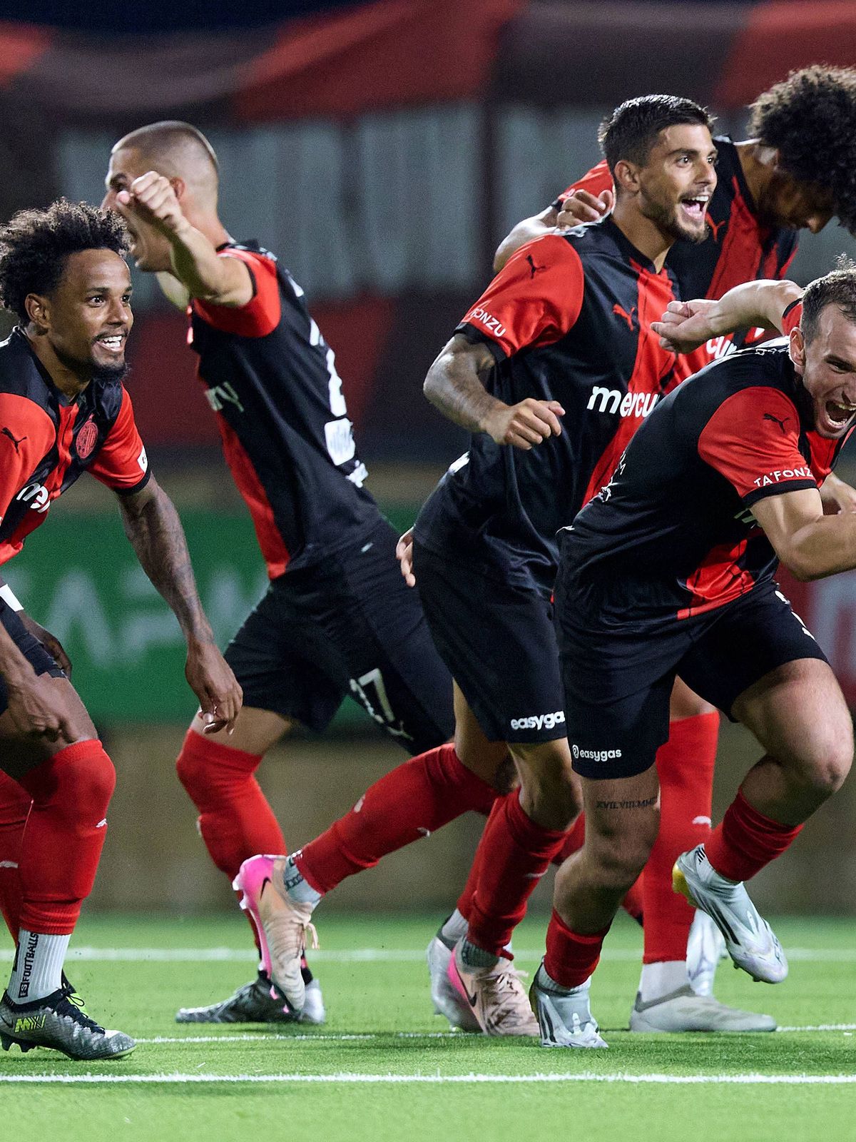 Hamrun Spartans players react in celebration after the decisive penalty scored by Jovan Cadjenovic (not in picture) during the penalty shoot out, after the UEFA Champions League First qualifying ro...