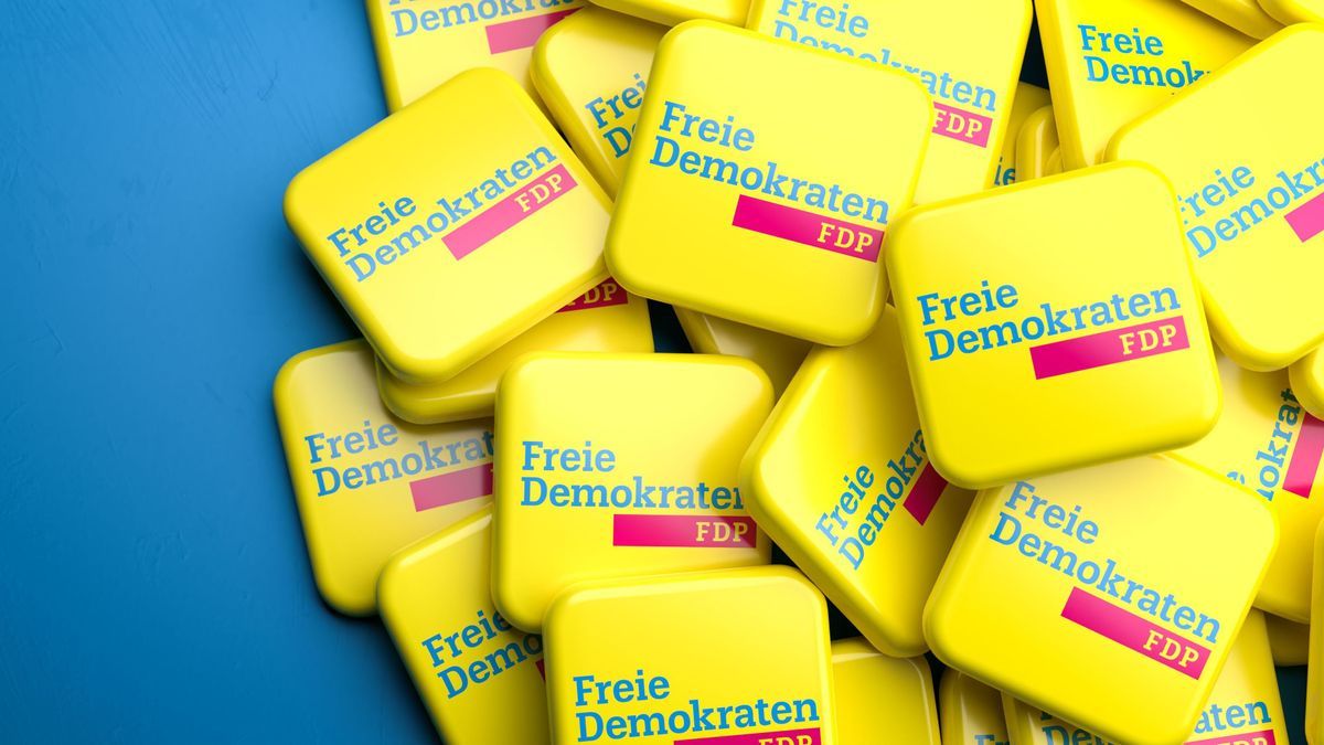 Logos of the liberal German political party FDP on a heap on a table. Copy space. Web banner format.