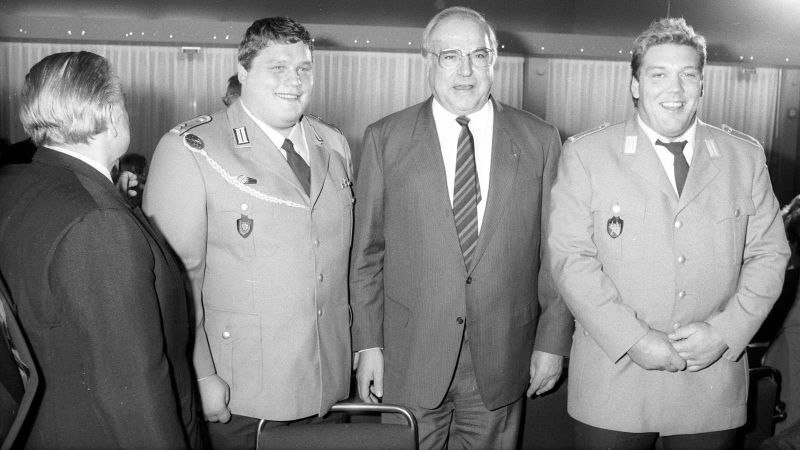 
                <strong>Helmut Kohl ist Bundeskanzler</strong><br>
                Zu jener Zeit ist Helmut Kohl (2. v. re.) bereits sechs Jahre Bundeskanzler und bleibt es auch noch bis nach der Wende ins Jahr 1998. Hier im Jahr 1988 empfängt Kohl die Olympia-Teilnehmer Manfred Nerlinger (2. v. li.) und Martin Zawieja (re.). Ebenfalls auf dem Bild: NOK-Präsident Willi Daume (li).
              
