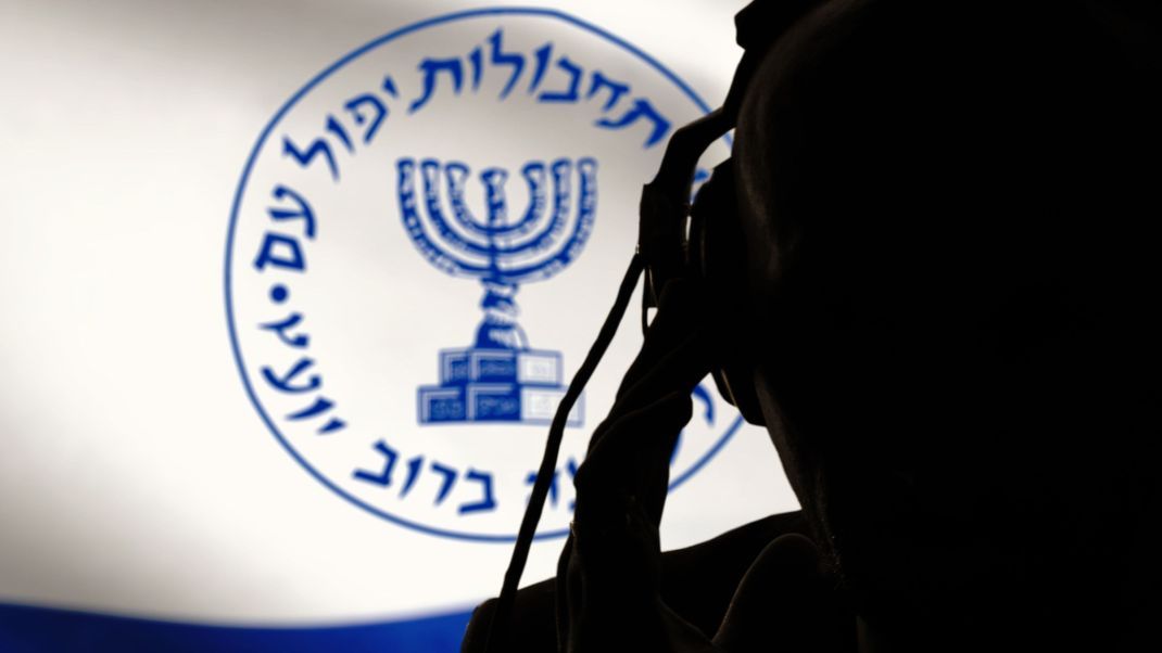 Secret agent of the Israeli intelligence eavesdropping on conversations, spy and special agent, the Israeli flag of the special services. Hebrew inscription, image of the menorah.