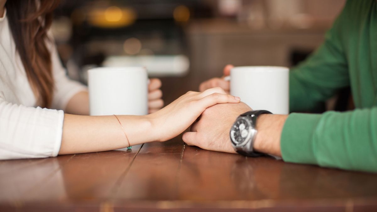 Holding hands at a coffee shop