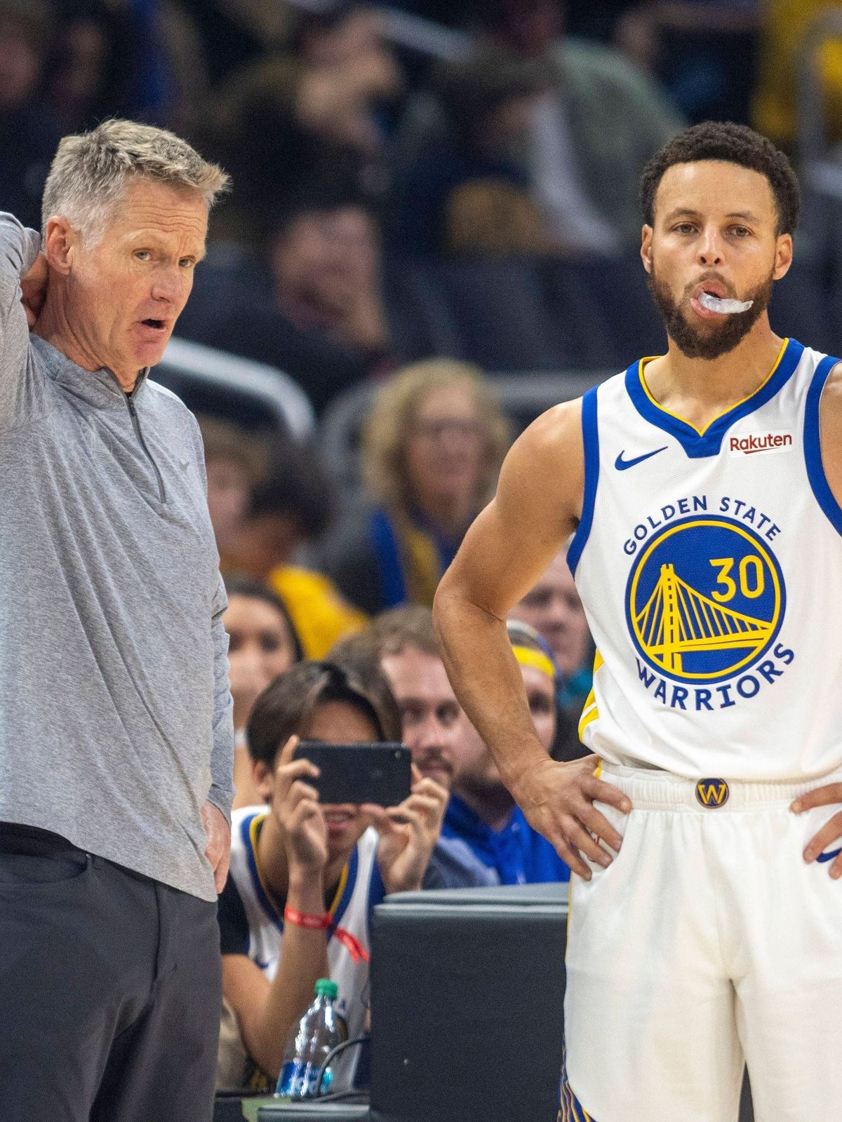 LOS ANGELES, CA - DECEMBER 02: Golden State Warriors head coach Steve Kerr talks with Golden State Warriors guard Stephen Curry (30) courtside during a break in the first half of an NBA, Basketball...